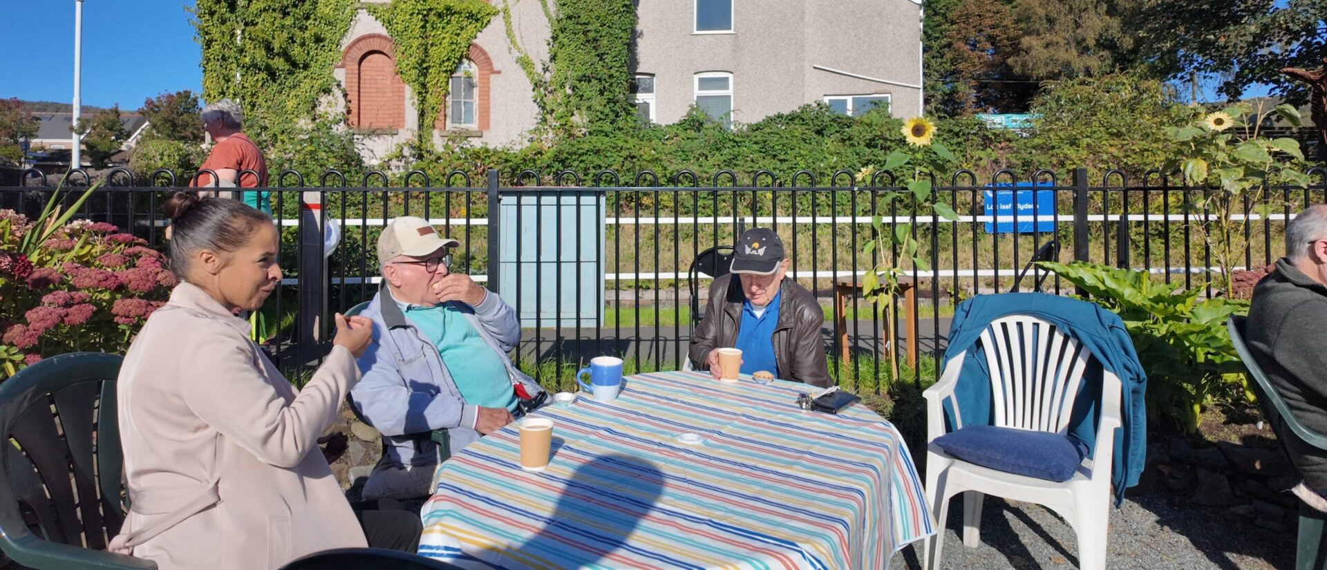 Emma sat with members of Men's Shed, Clydach