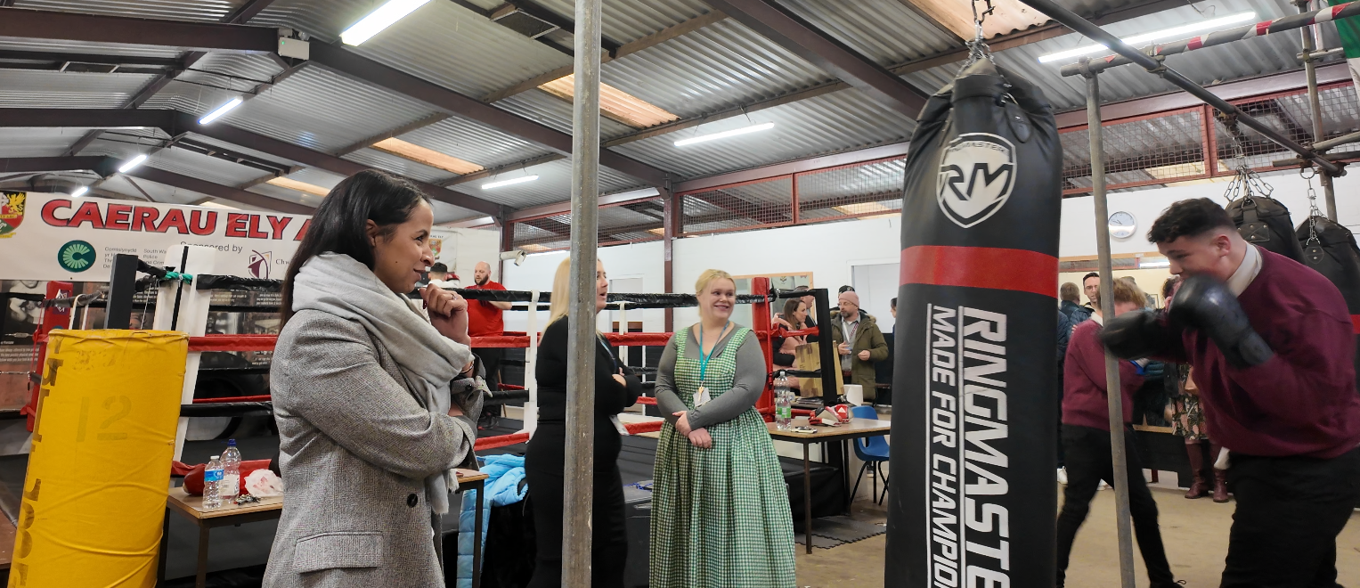 Picture of the Police & crime Commissioner, Emma Wools at caerau Ely boxing gym speaking to community members
