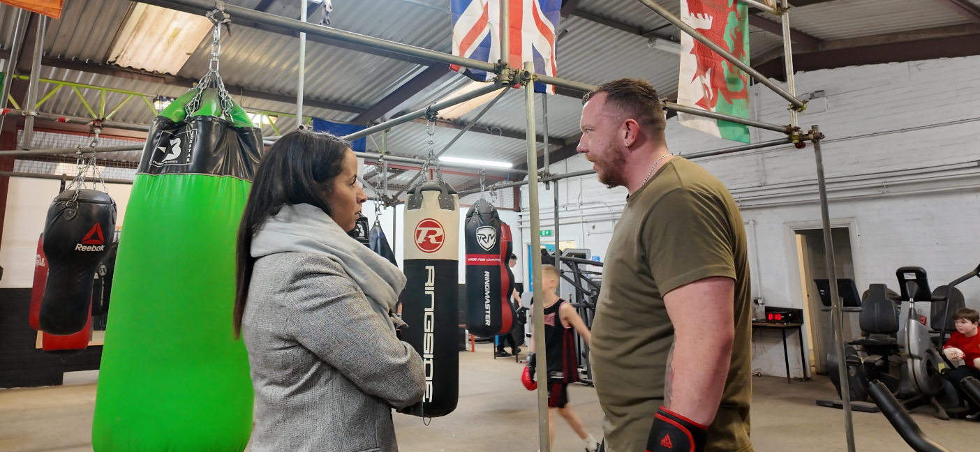 Picture of the Police & crime Commissioner, Emma Wools at caerau Ely boxing gym speaking to community members