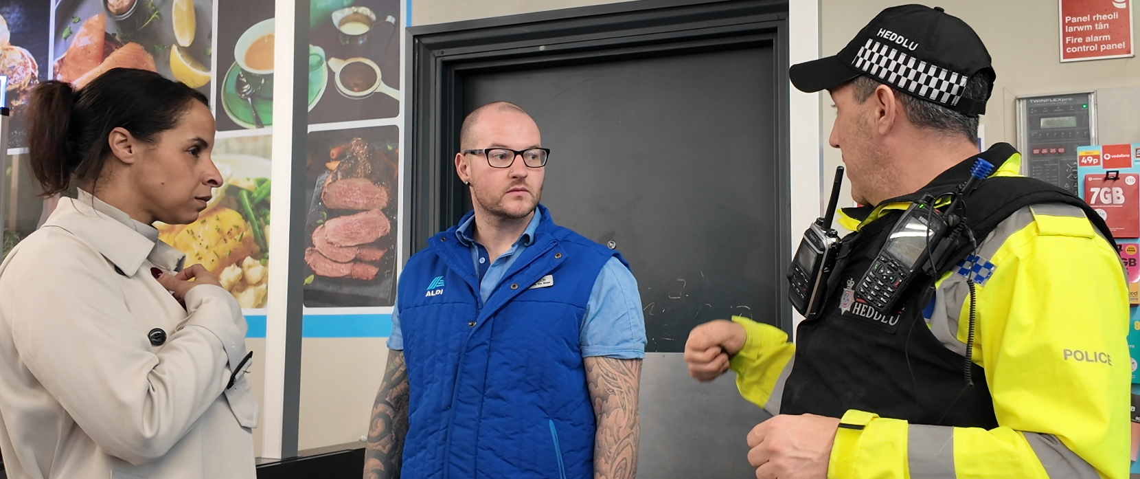 Police & Crime Commissioner, Emma Wools speaking with a Police Officer and shopworker